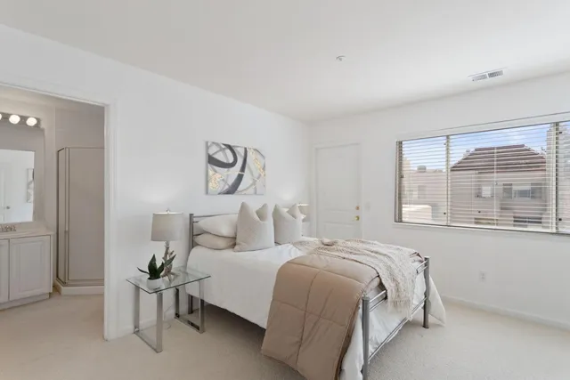 a bedroom with bed and a window