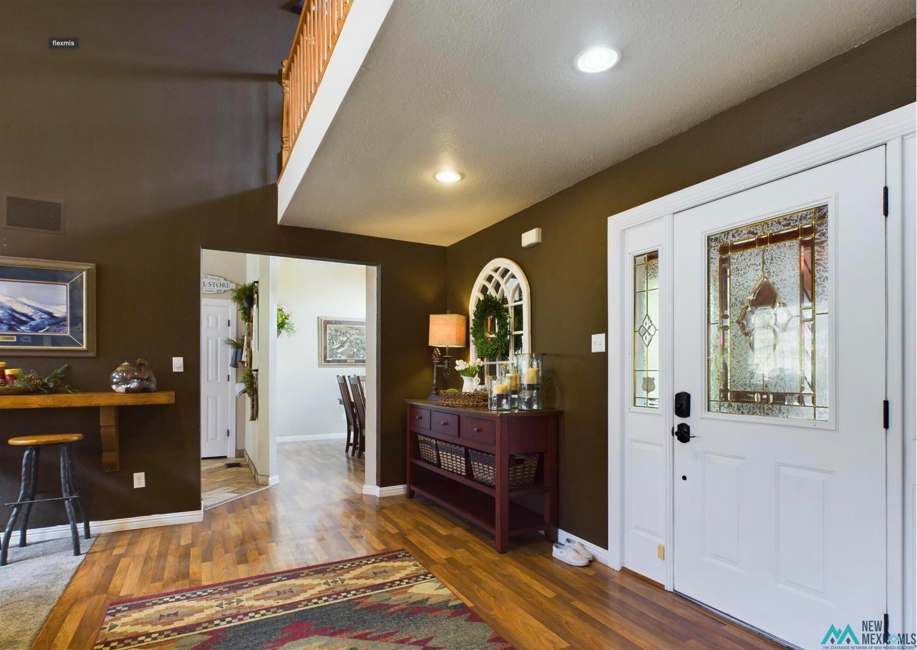 333 Ll Davis Drive Ruidoso, NM 88345 - Photo 7 of 25 Entryway featuring white door with decorative glass inserts, recessed lighting, and wood-finish flooring