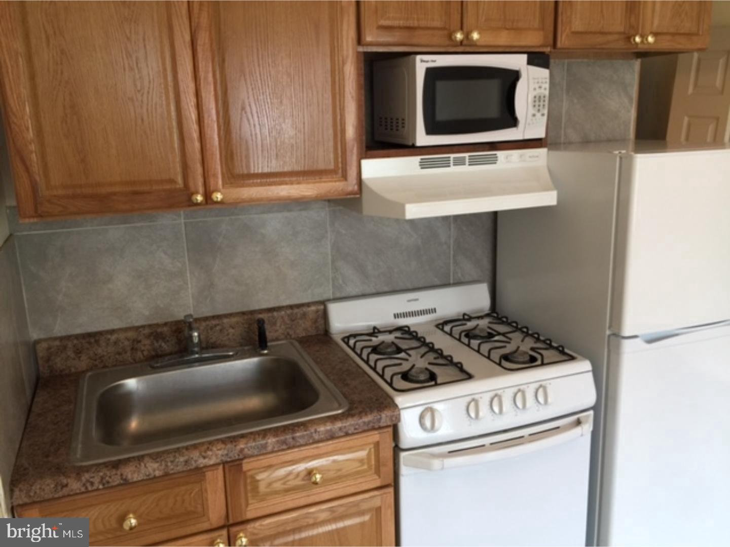 a kitchen with a stove and a microwave
