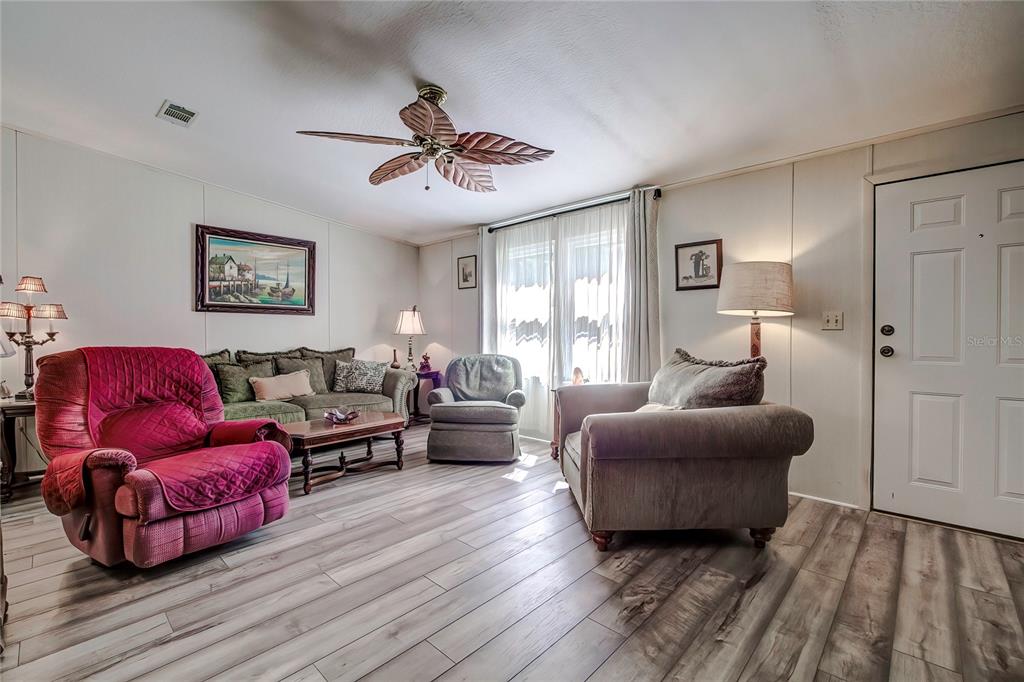 3307 Keye Drive Spring Hill, FL 34606 - Photo 11 of 29 a living room with furniture a ceiling fan and a window