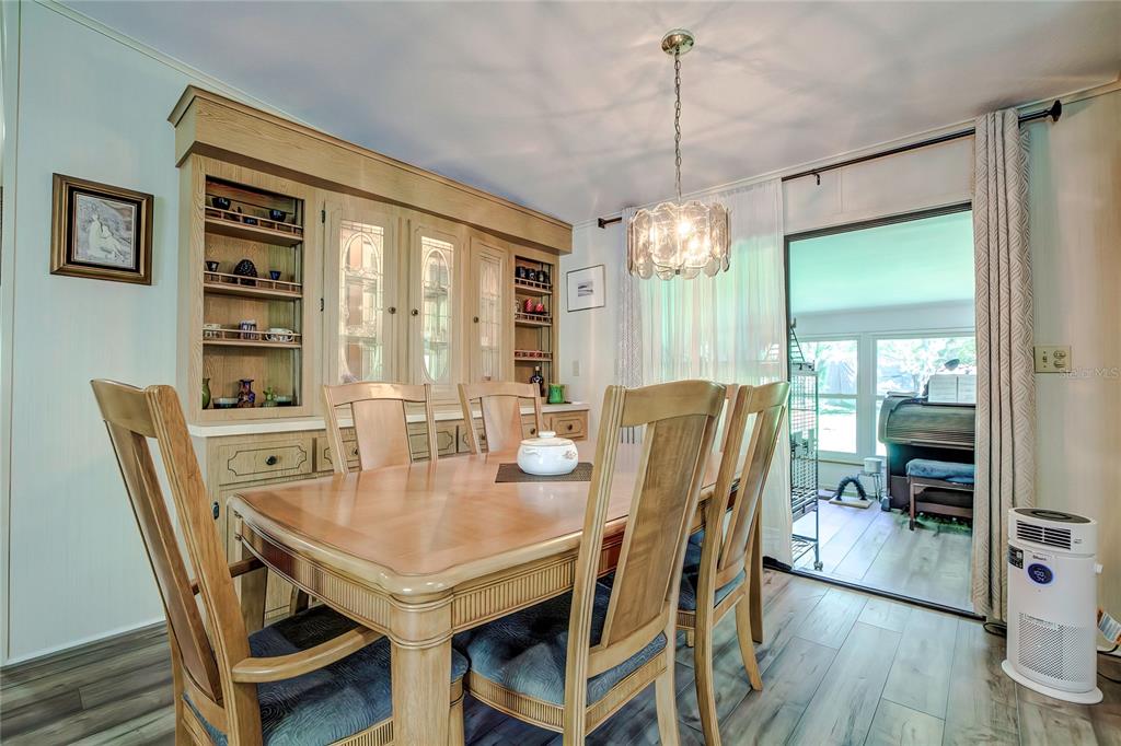 3307 Keye Drive Spring Hill, FL 34606 - Photo 16 of 29 a view of a dining room with furniture window and wooden floor