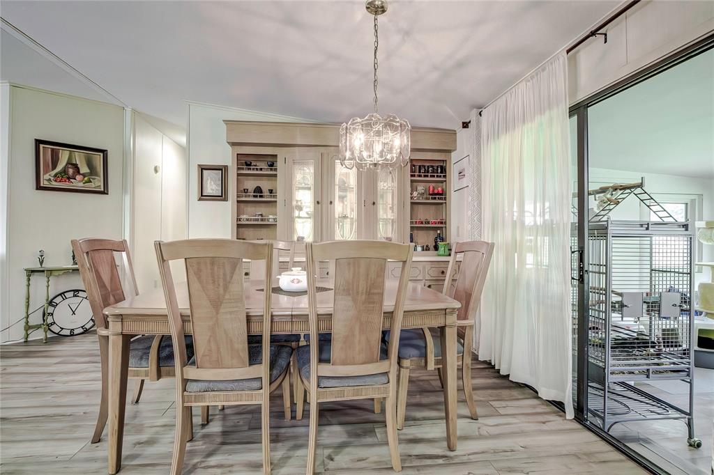 3307 Keye Drive Spring Hill, FL 34606 - Photo 17 of 29 a view of a dining room with furniture window and wooden floor