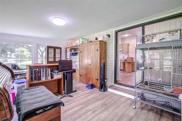 a living room with furniture a flat screen tv and a floor to ceiling window