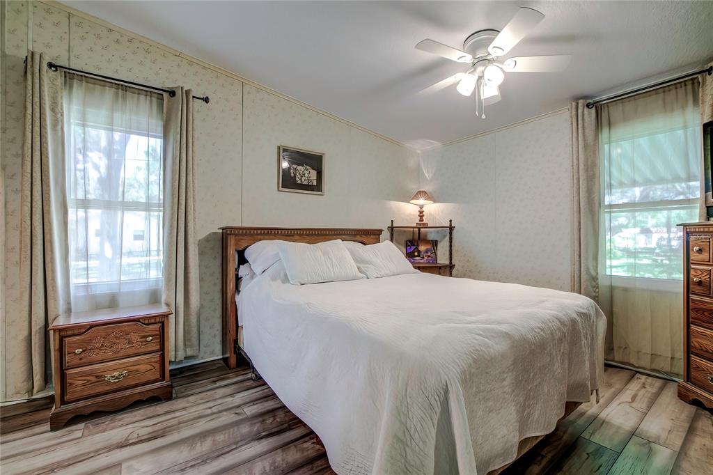 3307 Keye Drive Spring Hill, FL 34606 - Photo 20 of 29 a bedroom with a large bed and a chandelier