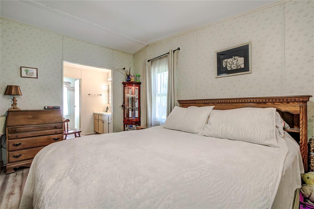 3307 Keye Drive Spring Hill, FL 34606 - Photo 21 of 29 a bed room with a bed and a lamp