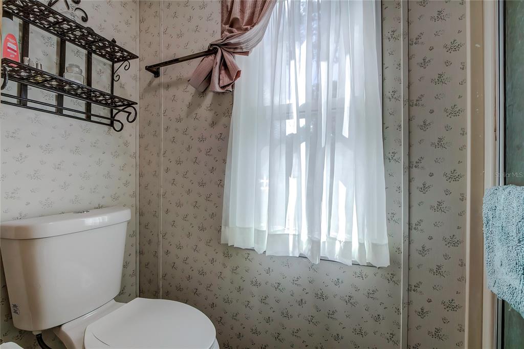 3307 Keye Drive Spring Hill, FL 34606 - Photo 26 of 29 a white toilet sitting next to a shower curtain