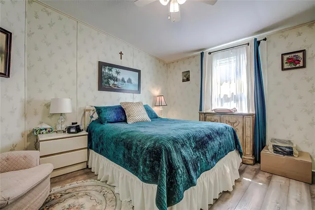 a spacious bedroom with a bed and window