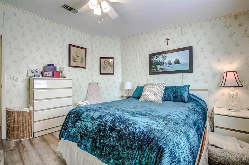 3307 Keye Drive Spring Hill, FL 34606 - Photo 28 of 29 a bedroom with a bed and a chandelier