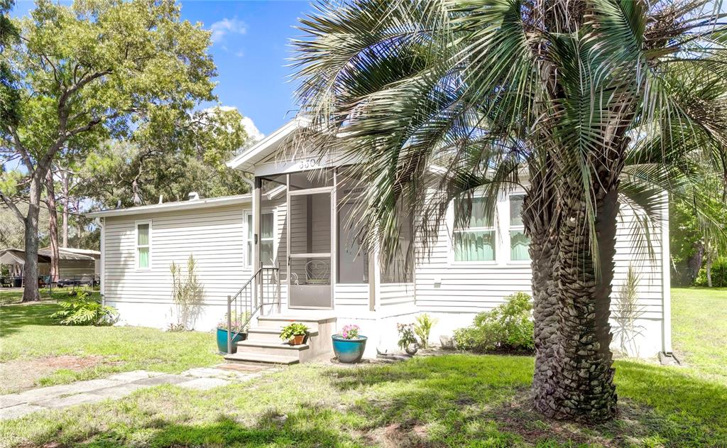 3307 Keye Drive Spring Hill, FL 34606 - Photo 3 of 29 a backyard of a house with table and chairs and potted plants