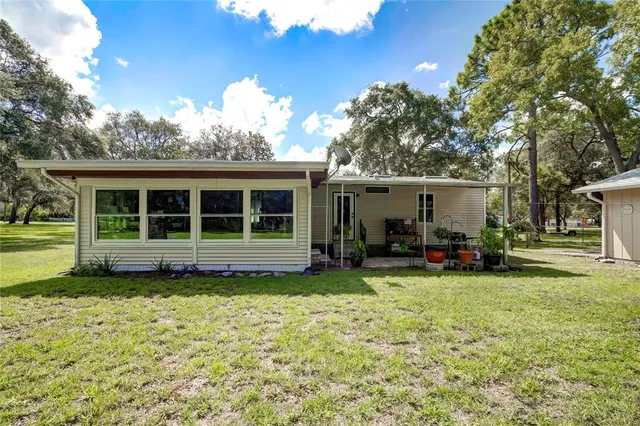 a view of a house with sitting area and garden