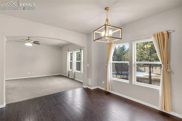 a view of a livingroom with a ceiling fan and window