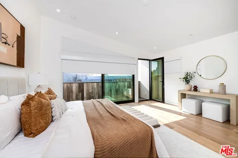 a bedroom with a large bed and a large window