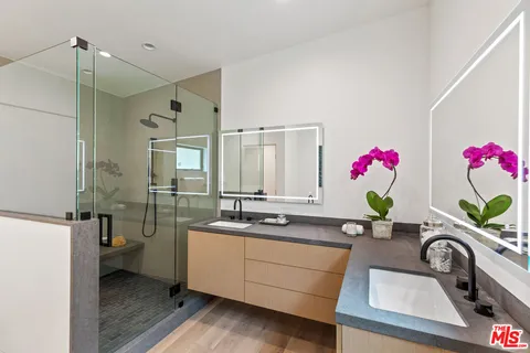 a bathroom with a sink mirror and a bathtub