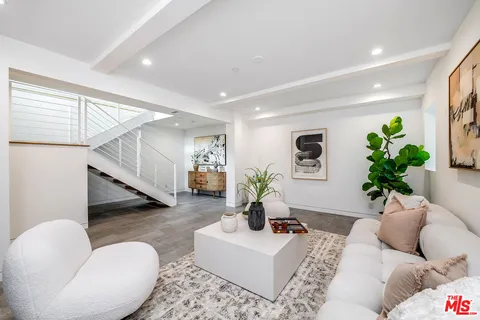 a living room with furniture and a potted plant