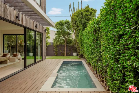 a view of a backyard with potted plants