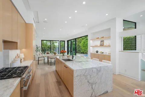 a kitchen with sink refrigerator and stove