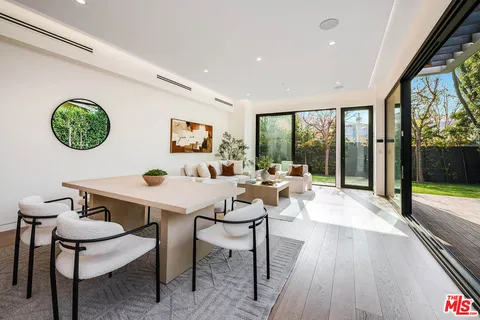 a view of a dining room with furniture wooden floor and a chandelier
