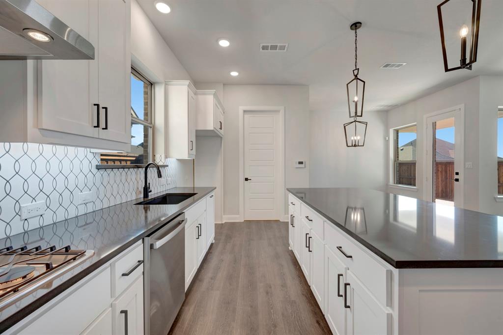 1857 Lightner Road Van Alstyne, TX 75495 - Photo 19 of 29 a kitchen with stainless steel appliances granite countertop a sink stove and refrigerator