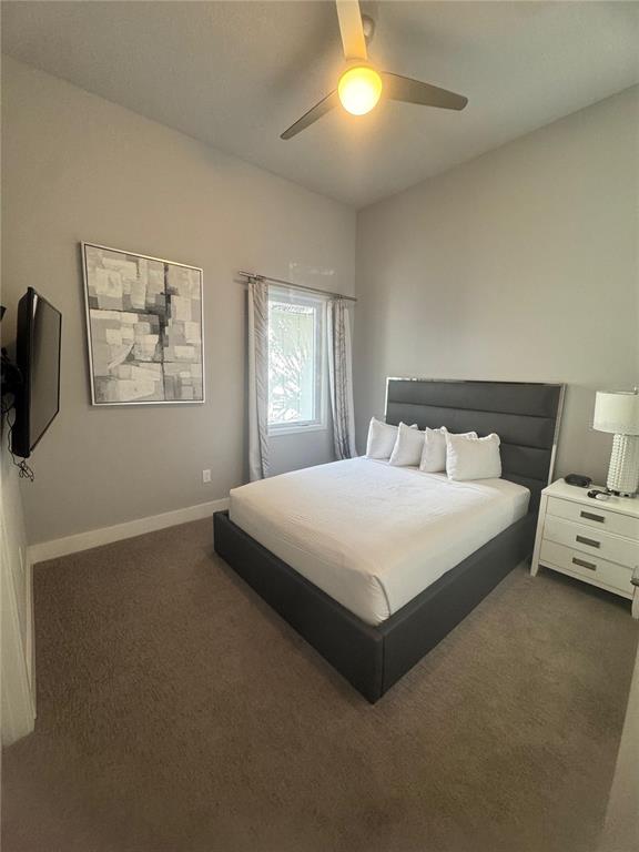 7770 Sandy Ridge Drive, Unit 210 Reunion, FL 34747 - Photo 13 of 42 a bedroom with a bed and painting on the wall