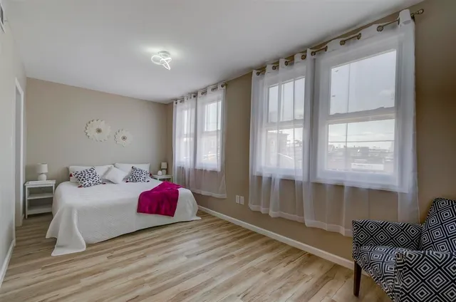 a bedroom with a bed and a window