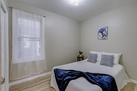 a bedroom with a bed and a window