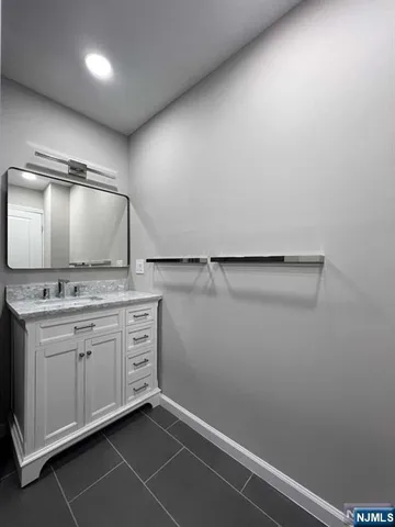 a large kitchen with stainless steel appliances a large counter top a sink a stove a refrigerator and cabinets