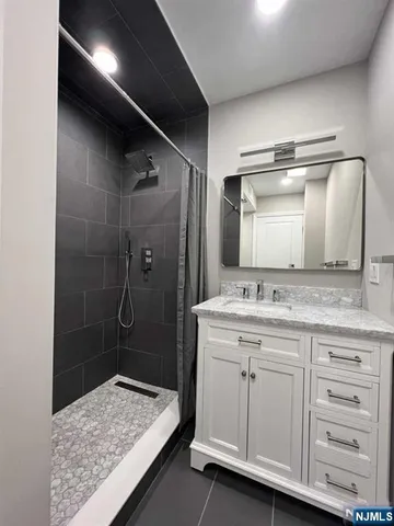 a kitchen with stainless steel appliances granite countertop a refrigerator a sink and a large window