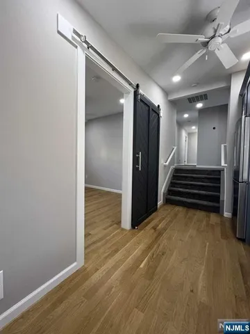 an empty room with staircase and white walls