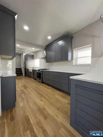 a view of an empty room with a fireplace and a window