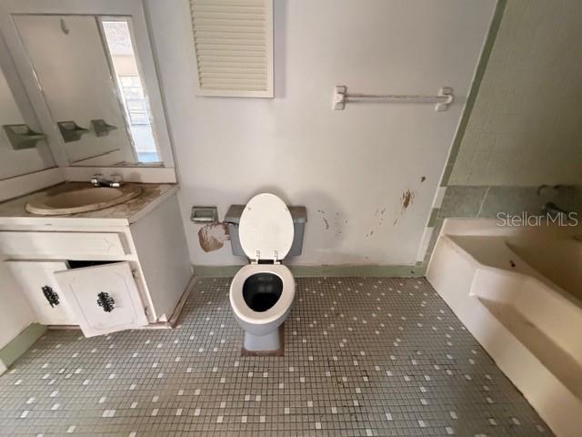 9764 Southwest 153rd Lane Dunnellon, FL 34432 - Photo 19 of 19 a bathroom with a sink toilet a mirror and vanity