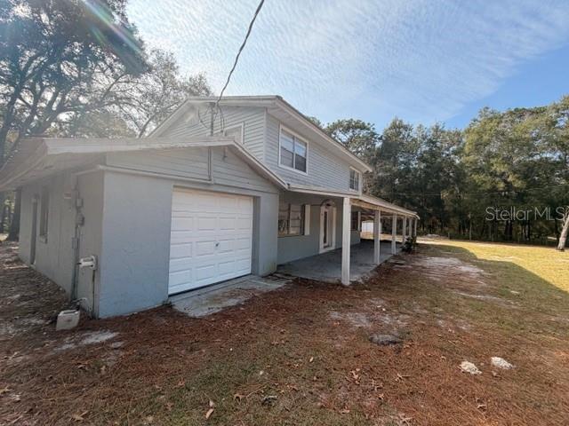 9764 Southwest 153rd Lane Dunnellon, FL 34432 - Photo 3 of 19 a view of a house with a yard