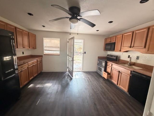 9764 Southwest 153rd Lane Dunnellon, FL 34432 - Photo 10 of 19 a kitchen with stainless steel appliances granite countertop a sink cabinets wooden floor and a window