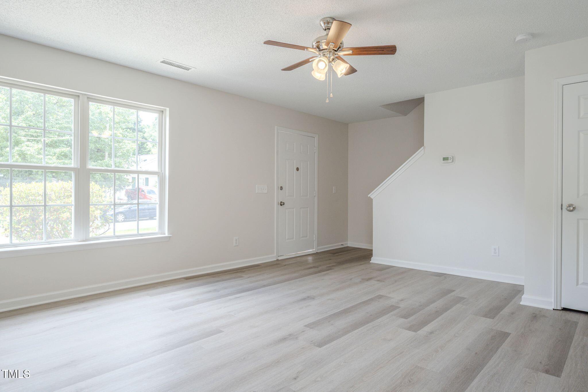 5522 Marthonna Way Raleigh, NC 27616 - Photo 3 of 21 wooden floor in an empty room with a window