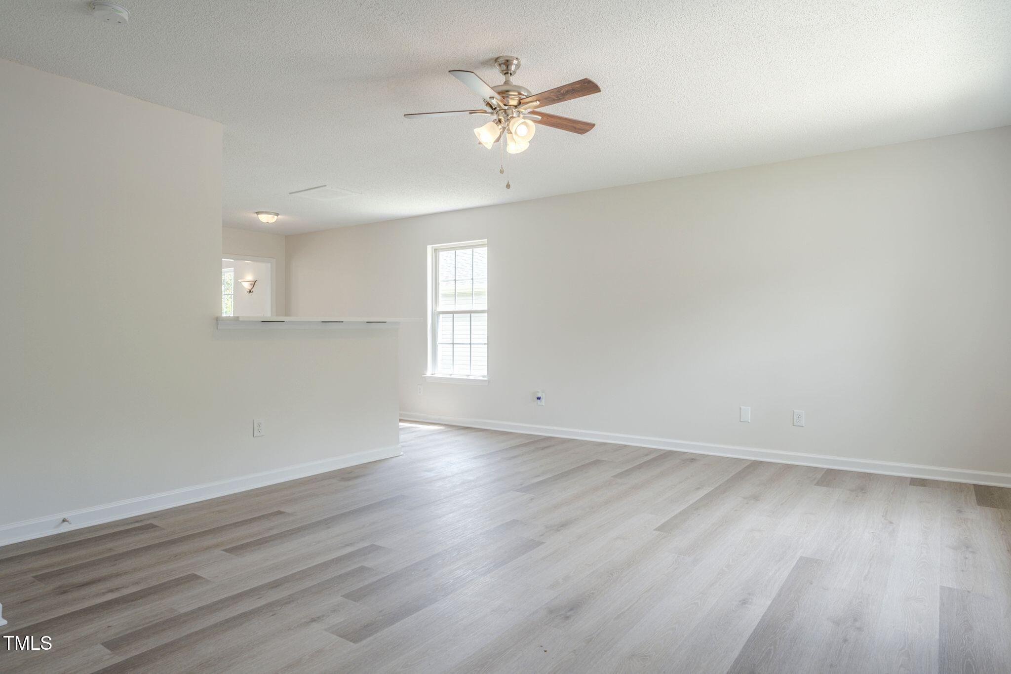 5522 Marthonna Way Raleigh, NC 27616 - Photo 4 of 21 an empty room with wooden floor and windows