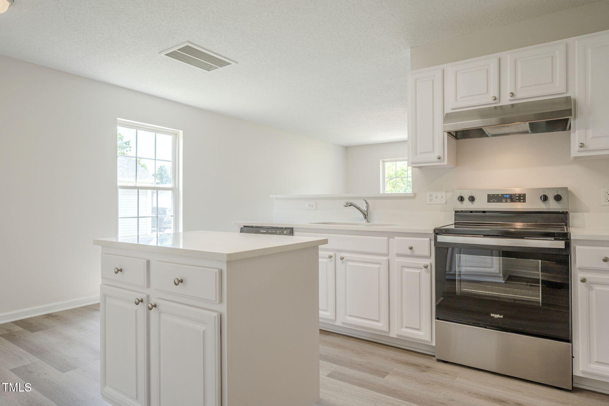 5522 Marthonna Way Raleigh, NC 27616 - Photo 7 of 21 a kitchen with cabinets appliances and a sink