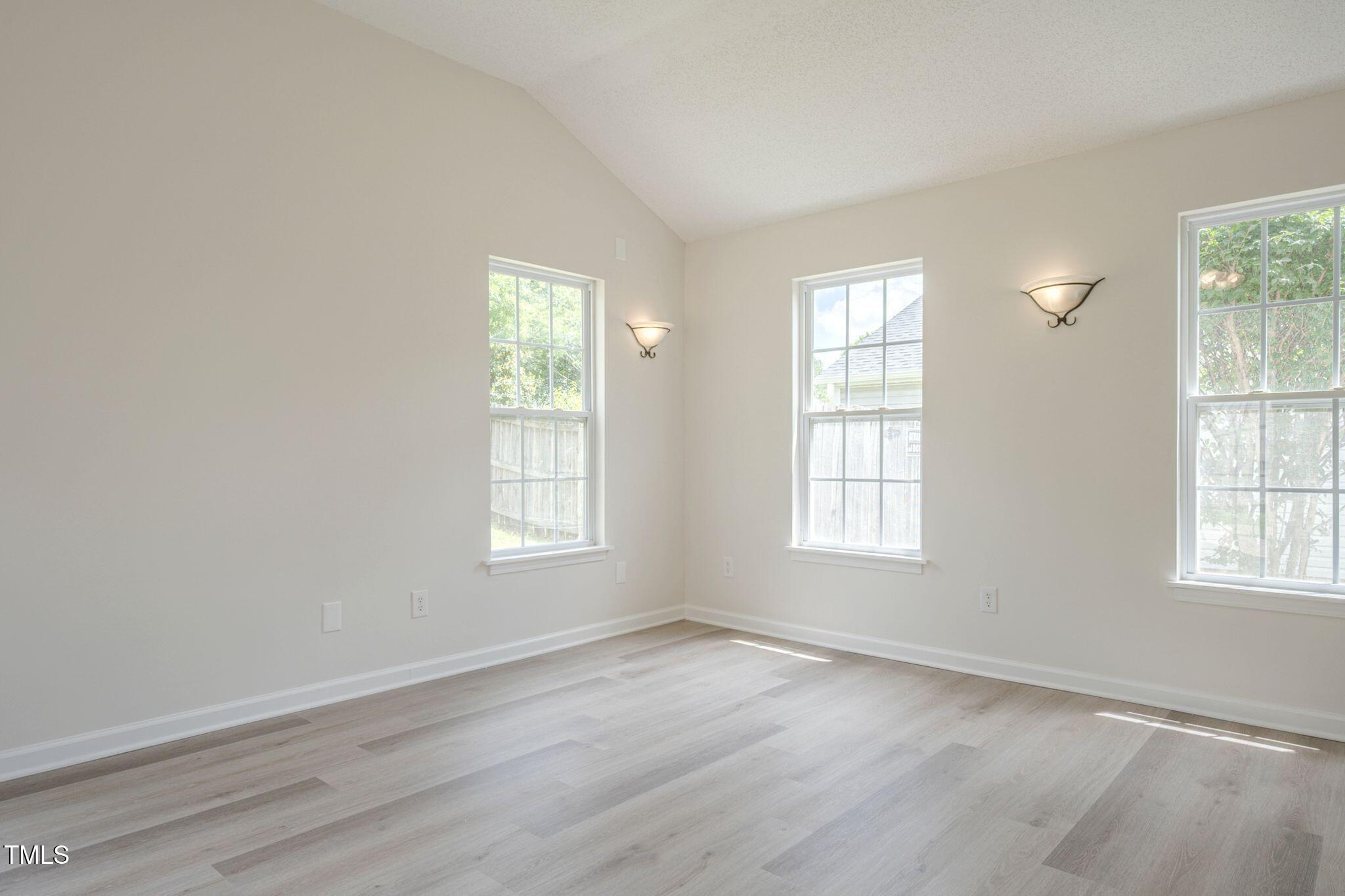 5522 Marthonna Way Raleigh, NC 27616 - Photo 9 of 21 an empty room with wooden floor and windows