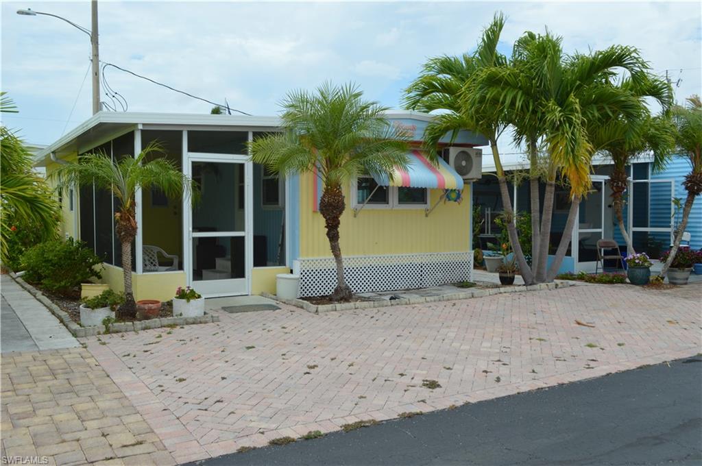 414 Papaya Street, Unit C Goodland, FL 34140 - Photo 2 of 13 a view of a house with a backyard
