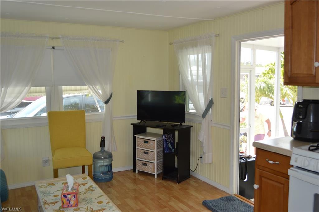 414 Papaya Street, Unit C Goodland, FL 34140 - Photo 3 of 13 a living room with furniture and a flat screen tv