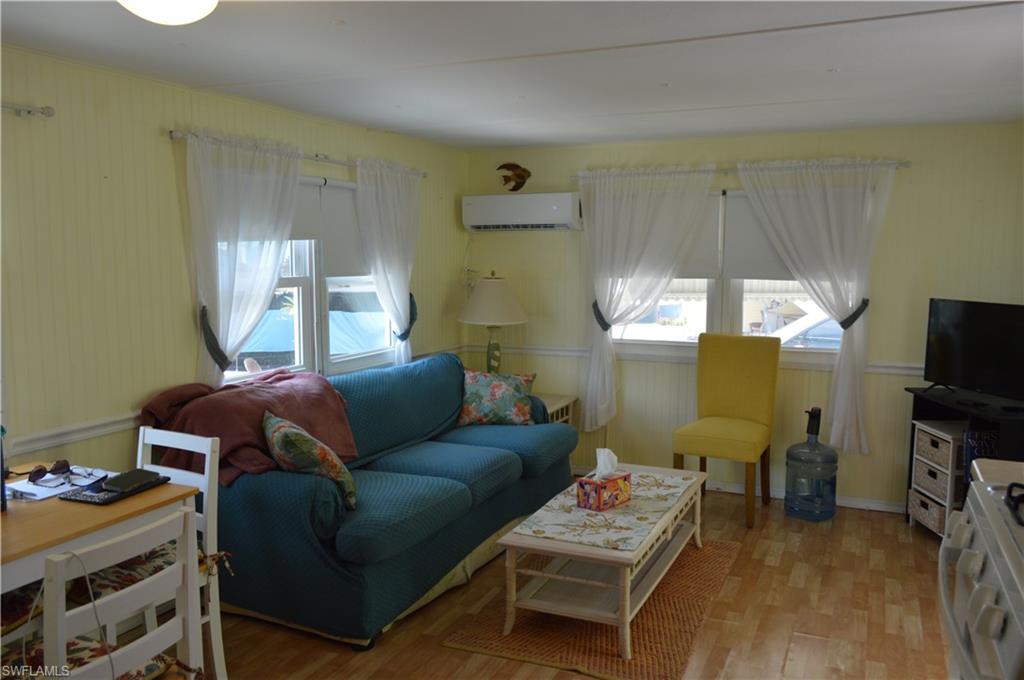 414 Papaya Street, Unit C Goodland, FL 34140 - Photo 4 of 13 a living room with furniture and a flat screen tv