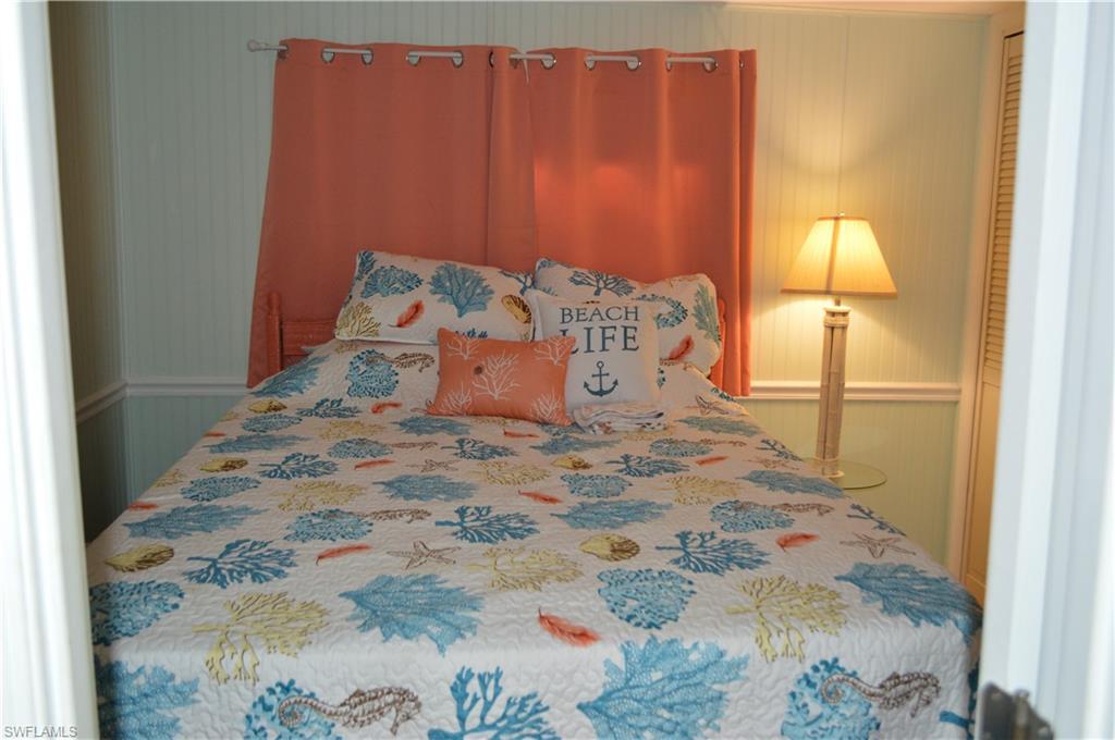 414 Papaya Street, Unit C Goodland, FL 34140 - Photo 7 of 13 a large bed sitting in a bedroom next to a window