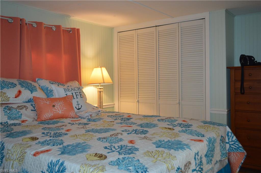 414 Papaya Street, Unit C Goodland, FL 34140 - Photo 8 of 13 a bedroom with a bed and a dresser