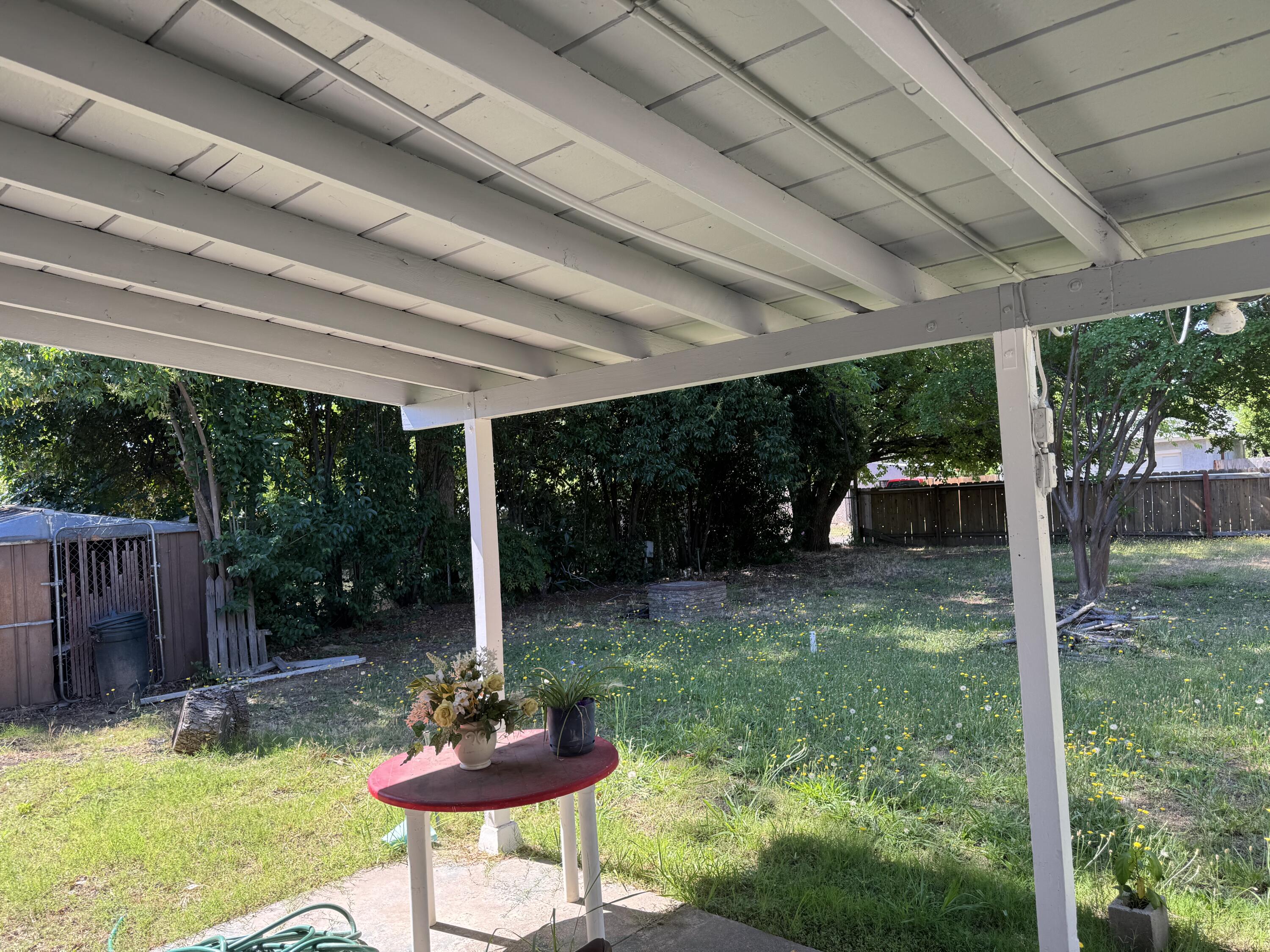1015 Gold Street Redding, CA 96001 - Photo 6 of 17 a backyard of a house with a fountain table and chairs