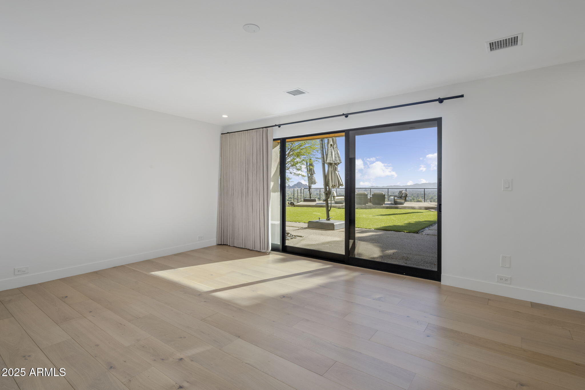 5419 East Valle Vista Road Phoenix, AZ 85018 - Photo 45 of 71 a view of an empty room with a fireplace and a large window
