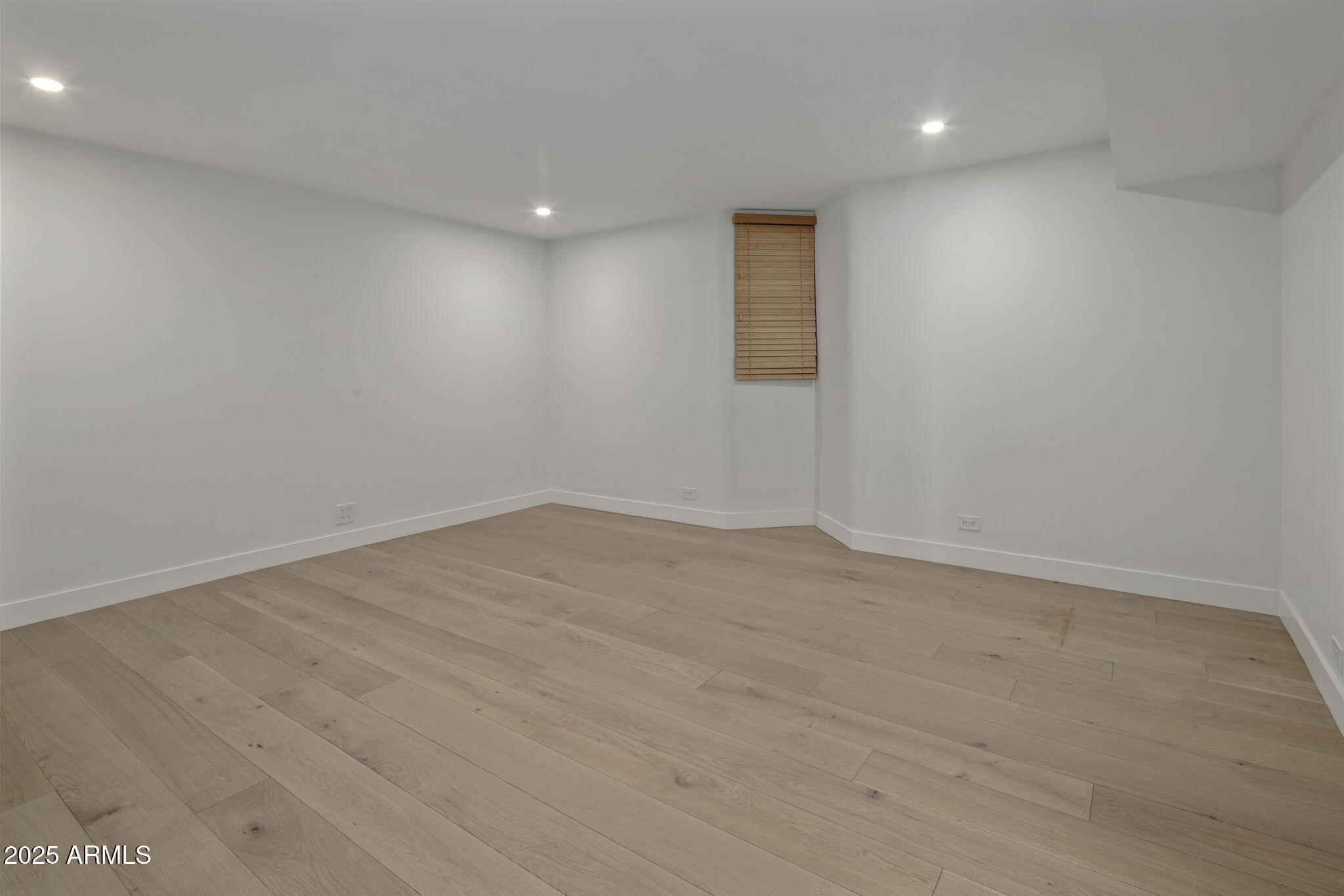 5419 East Valle Vista Road Phoenix, AZ 85018 - Photo 47 of 71 an empty room with wooden floor and windows