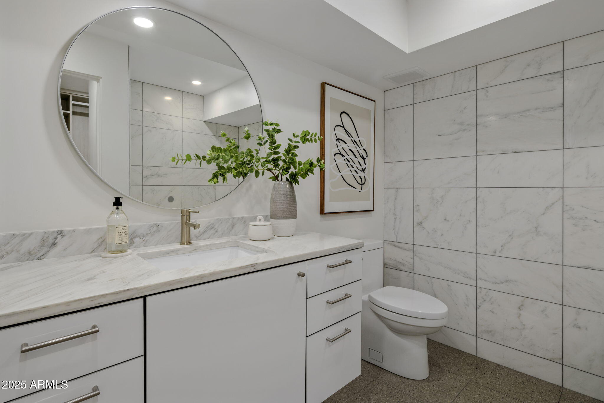 5419 East Valle Vista Road Phoenix, AZ 85018 - Photo 49 of 71 a bathroom with a toilet sink and mirror