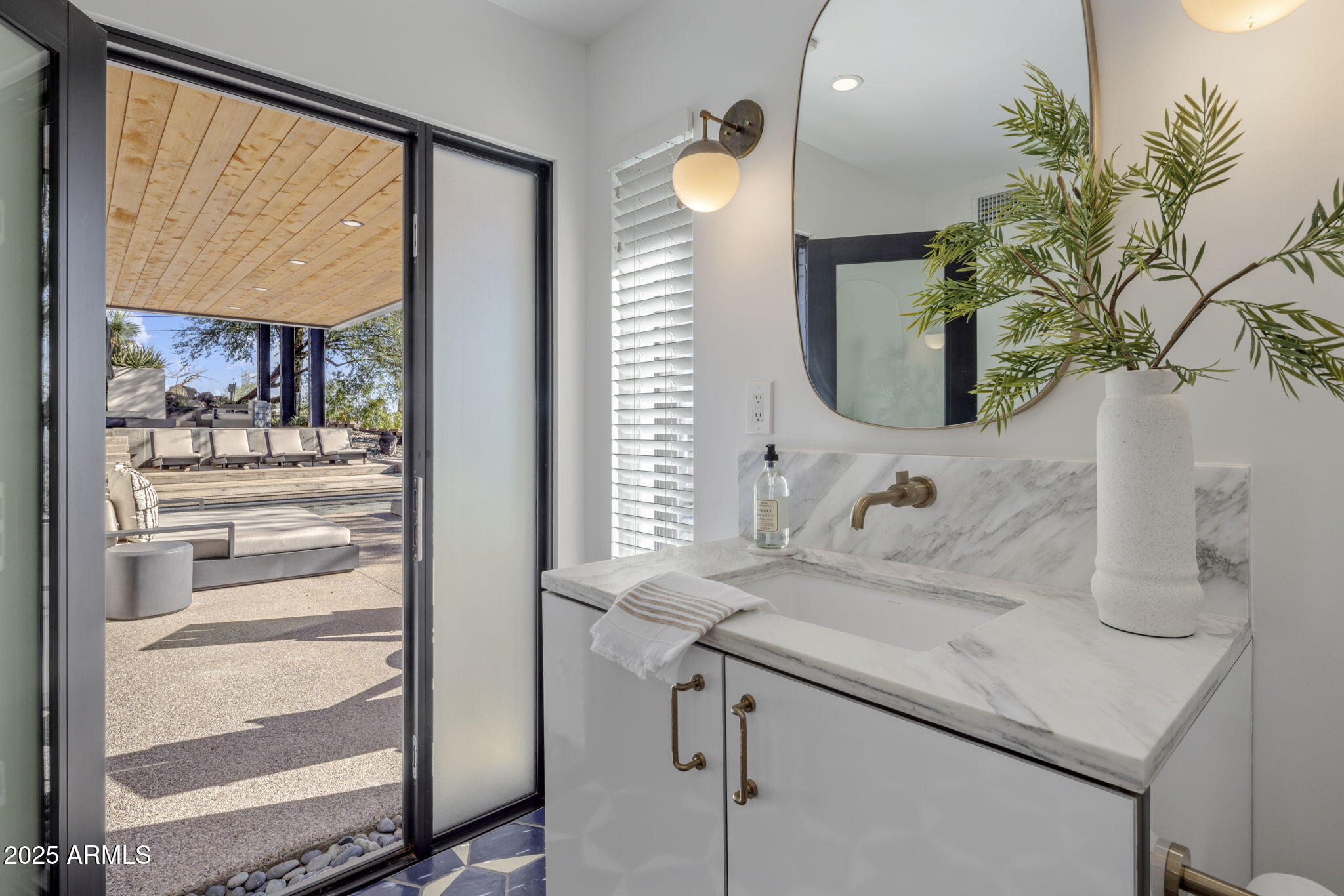5419 East Valle Vista Road Phoenix, AZ 85018 - Photo 50 of 71 a bathroom with a sink and a mirror