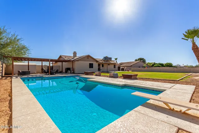 a front view of house with outdoor space and swimming pool