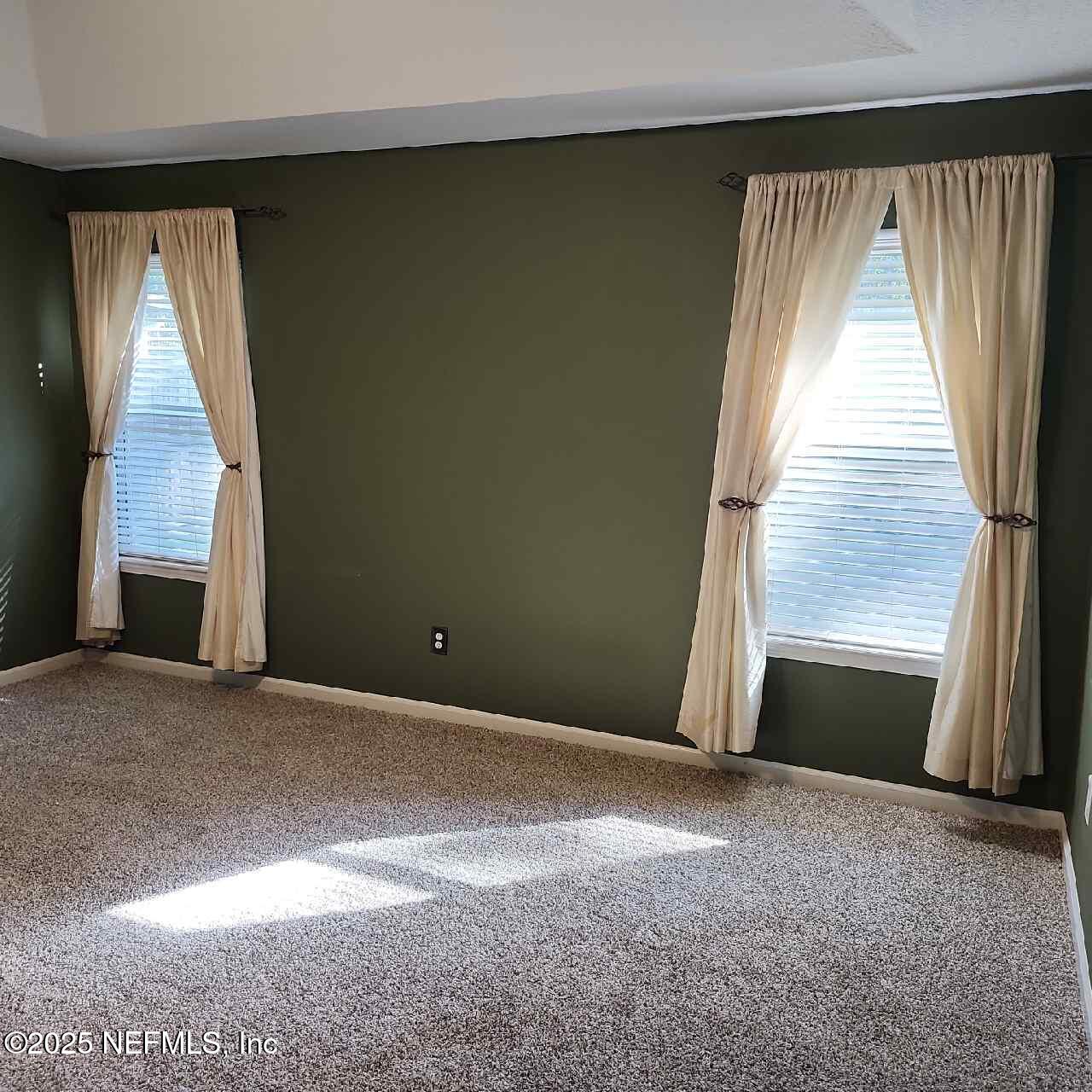 96203 Ridgewood Circle Fernandina Beach, FL 32034 - Photo 13 of 20 a view of an empty room with a fireplace and a window