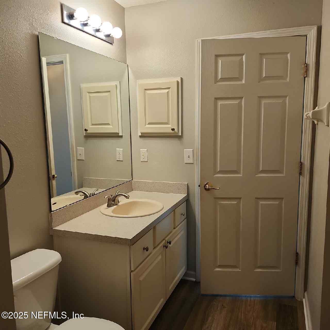 96203 Ridgewood Circle Fernandina Beach, FL 32034 - Photo 16 of 20 a bathroom with a granite countertop sink toilet and mirror