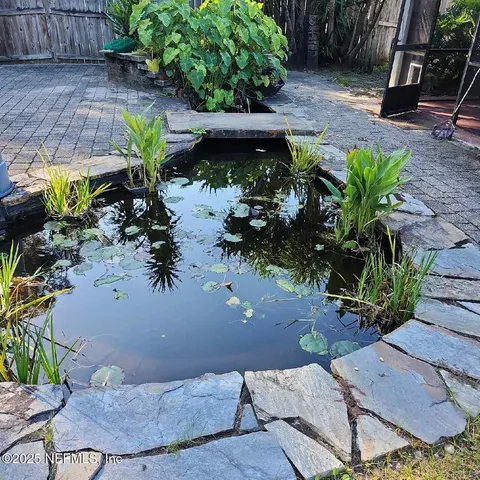 a view of a backyard with plants and a patio